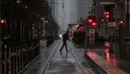 A man crosses Main Street in downtown during record-breaking temperatures in Houston, U.S., February 17, 2021. REUTERS/Adrees Latif

