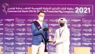 Germany’s Christian Ahlmann, the  CHI Al Shaqab Grand Prix winner who captured major honours on the final day of the Commercial Bank CHI Al Shaqab Presented by Longines, receiving his trophy from Event Director and Organising Committee Member Omar Al Mann