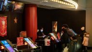 Guests purchase tickets at the AMC movie theatre in Lincoln Square, amid the coronavirus disease (COVID-19) pandemic, in the Manhattan borough of New York City, New York, U.S., March 6, 2021. REUTERS/Jeenah Moon
