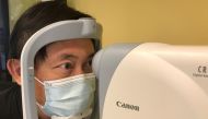 Benny Zee, a scientist from the Chinese University of Hong Kong, demonstrates retinal eye scanning technology used for early detection of autism during an interview with Reuters in Hong Kong, China January 29, 2021. Picture taken January 29, 2021. Reuters
