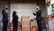 U.S. President Joe Biden speaks with owners James Smith and Kristin Smith during a 