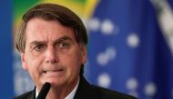 FILE PHOTO: Brazil's President Jair Bolsonaro reacts during a ceremony to expand the ability of the government to purchase vaccines against COVID-19, amid the coronavirus disease (COVID-19) outbreak, in Brasilia, Brazil, March 10, 2021. REUTERS/Ueslei Mar