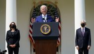 U.S. President Joe Biden is flanked by Vice President Kamala Harris and Attorney General Merrick Garland as he announces executive actions on gun violence prevention in the Rose Garden at the White House in Washington, U.S., April 8, 2021. REUTERS/Kevin L