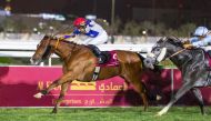 Bottom Bay, ridden by Saleh Salem Al Marri, crosses the finish line to win the Al Mamoura Cup at QREC's Al Rayyan Park yesterday. 