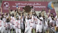 Second Division champions Al Shamal players celebrate with the League trophy.