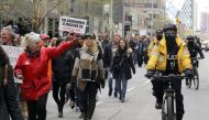 Police offcers ride bikes as demonstrators protest against new coronavirus disease (COVD-19) restrictions, in Toronto, Canada April 17, 2021. REUTERS/Chris Helgren
