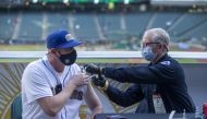 May 4, 2021; Seattle, Washington, USA; Seattle Fire Department EMT Bill Allemann gives Chris Hoffman, of Kent, Washington a Johnson & Johnson Covid-19 vaccine during batting practice before a game between the Seattle Mariners and Baltimore Orioles at T-Mo