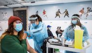 FILE PHOTO: Healthcare workers from Switch Health administer the Pfizer/BioNTech COVID-19 vaccine at the Ontario Khalsa Darbar pop-up vaccination clinic, set up with support from Amazon Canada, at the Sikh Gurudwara in Mississauga, Ontario, Canada May 4, 