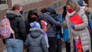 A principal greets students as they return to New York City's public schools for in-person learning, as the global outbreak of the coronavirus disease (COVID-19) continues, at P.S. 506 in Brooklyn, New York, U.S., December 7, 2020. REUTERS/Brendan McDermi