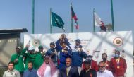 The podium winners of the Men's Skeet Team Event pose for a photograph with officials.