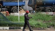 A police officer sets to fire tear gas as he tries to disperse protesters during a June 12 Democracy Day protest at the Gani Fawehinmi Park, in Ojota, Lagos, Nigeria June 12, 2021. REUTERS/Temilade Adelaja