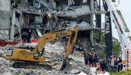 Emergency workers conduct search and rescue missions at the site of a partially collapsed residential building in Surfside, near Miami Beach, Florida, U.S. June 28, 2021. REUTERS/Joe Skipper
