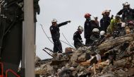 Rescue personnel continue the search and rescue operation for survivors at the site of a partially collapsed residential building in Surfside, near Miami Beach, Florida, U.S. June 30, 2021. REUTERS/Marco Bello/File Photo