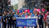 People take part in the Hometown Heroes ticker tape parade, to honor essential workers for their work during the outbreak of the coronavirus disease (COVID-19), up New York City's 
