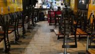 Chairs are stacked on tables inside a city centre restaurant serving takeaway but closed for dine-in during a lockdown to curb the spread of a coronavirus disease (covid-19) outbreak in Sydney, Australia, July 12, 2021. REUTERS/Loren Elliott
