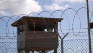 A soldier stands guard in a tower overlooking Camp Delta at Guantanamo Bay naval base in a December 31, 2009 file photo. (Reuters/US Navy)

