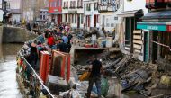Police officers and volunteers clean rubble in an area affected by floods caused by heavy rainfalls in Bad Muenstereifel, Germany, July 18, 2021. REUTERS/Thilo Schmuelgen

