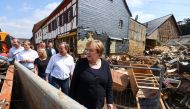 German Chancellor Angela Merkel and North-Rhine Westphalian State Premier Armin Laschet visit the area affected by floods caused by heavy rainfalls, in Iversheim, a suburb of Bad Muenstereifel, North-Rhine Westphalian state, Germany July 20, 2021. REUTERS