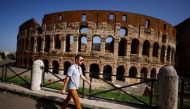 A person walks without wearing a mask as Italy lifts mandatory masks outdoors thanks to a decline in the coronavirus disease (COVID-19) cases and hospitalisations, in Rome, Italy, June 28, 2021. REUTERS/Guglielmo Mangiapane