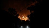 A view of smoke rising from a wildfire is seen from Kifisia, northern suburb of Athens, Greece, August 3, 2021. Fotis Chormovitis via Reuters 