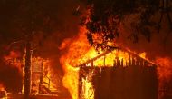 A house is fully engulfed by flames at the Dixie Fire, a wildfire near the town of Greenville, California, U.S. August 5, 2021. REUTERS/Fred Greaves