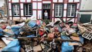 A man looks on outside a house in an area affected by floods caused by heavy rainfalls in Bad Muenstereifel, Germany, July 19, 2021. REUTERS/Wolfgang Rattay/File Photo