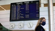 FILE PHOTO: A woman walks by the arrivals information board at Porto Airport on the first day that tourists from Britain and most EU countries are allowed to enter Portugal without needing to quarantine, as coronavirus disease (COVID-19) restrictions cont