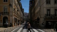 FILE PHOTO: A person wearing a protective mask walks in Lisbon downtown amid the coronavirus disease (COVID-19) pandemic, in Lisbon, Portugal, June 24, 2021. REUTERS/Pedro Nunes/File Photo