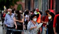 People queue to receive a vaccine against the coronavirus disease (COVID-19), during a night of vaccinations with music, at the Arena Treptow vaccination centre in Berlin, Germany, August 9, 2021. John Macdougall/Pool via REUTERS