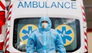A medical worker wearing protective gear stands next to an ambulance outside a hospital for patients infected with the coronavirus disease (COVID-19) in Kyiv, Ukraine November 24, 2020. REUTERS/Gleb Garanich/File Photo/File Photo
