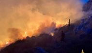 Firefighters battle wildfires in the beach village of Porto Badisco near Otranto in the southern region of Puglia, Italy, August 13, 2021. Vigili del Fuoco/Handout via REUTERS

