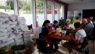 Volunteers prepare food for people affected by the floods after heavy rainfall in Jupille, Belgium, August 9, 2021. REUTERS/Johanna Geron