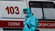 A medical specialist walks by an ambulance outside a hospital for patients infected with coronavirus disease (COVID-19) in Moscow, Russia June 16, 2021. REUTERS/Maxim Shemetov