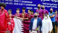 Khalil Ahmad Al Mohannadi, President of the Arab Table Tennis Federation and Qatar Table Tennis Association and First Vice-President of the International Table Tennis Federation, poses for a photograph with an official and the Qatar U-13 team members and 
