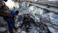 People look for survivors at a house destroyed following a 7.2 magnitude earthquake in Les Cayes, Haiti August 14, 2021. REUTERS/Ralph Tedy Erol 