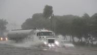 Vehicles move through a flooded street during the passage of Tropical Storm Fred in Santo Domingo, Dominican Republic August 11, 2021. REUTERS/Ricardo Rojas

