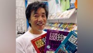 File photo: 'Father of Sudoku' Maki Kaji holds copies of the latest sudoku puzzles at the Book Expo, in New York, June 3, 2007. REUTERS/Chip East/File Photo

