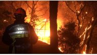 A firefighter works near at the site of a wildfire that broke out in the Var region of southern France, August 17, 2021 Communication SDIS19/Handout via REUTERS