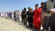 People wait outside Hamid Karzai International Airport in Kabul, Afghanistan August 17, 2021. REUTERS/Stringer