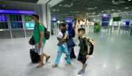 A family of German citizens walk with their bags in the airport terminal upon arrival at Frankfurt Airport, Germany, August 18, 2021, after being evacuated from Kabul, Afghanistan. Reuters/Thilo Schmuelgen