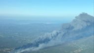 Smoke rises from a major wildfire that broke out in the Var region of southern France, August 16, 2021. Picture taken August 16, 2021. Securite Civile