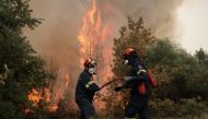 Firefighters try to extinguish a fire in the village of Avgaria, on the island of Evia, Greece, August 10, 2021. REUTERS/Stelios Misinas