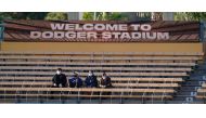 May 14, 2021; Los Angeles, California, USA; Fans in the left field bleachers at Dodger Stadium wear masks before the start of the Dodgers game against the Miami Marlins. As the CDC loosens restrictions many cites and venues are still requiring people to w
