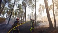 Firefighters extinguish a fire that broke out in Vidauban, in the Var region of southern France, August 18, 2021. REUTERS/Eric Gaillard