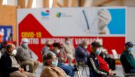 People wait in a COVID-19 vaccination centre, as Portugal resumes vaccination with AstraZeneca shots after a temporary suspension, amid the coronavirus disease (COVID-19) pandemic, in Seixal, Portugal, March 22, 2021. REUTERS/Pedro Nunes//File Photo