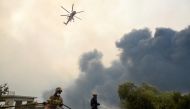 Firefighters try to extinguish fires as a wildfire continues to rage near the village of Afidnes, north of Athens, Greece, August 6, 2021. REUTERS/Alexandros Avramidis/File Photo