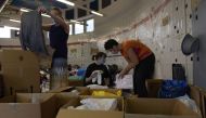Civilian volunteers sort donations for evacuees from Afghanistan at Ramstein Air Base, Germany, August 22, 2021. Picture taken August 22, 2021. Airman 1st Class Madelyn Keech/U.S. Air Force