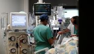 FILE PHOTO - Healthcare workers adjust medical equipment in the Intensive Care Unit (ICU) at the Centre Cardiologique du Nord private hospital in Saint-Denis, near Paris, amid the coronavirus disease (COVID-19) pandemic in France, May 4, 2021. REUTERS/Ben