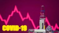 FILE PHOTO: A test tube labelled with the Vaccine is seen in front of Covid-19 and stock graph logo in this illustration taken, September 9, 2020. REUTERS/Dado Ruvic/Illustration/File Photo
