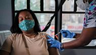 A person receives a dose of the Pfizer-BioNTech vaccine for the coronavirus disease (COVID-19), at a mobile inoculation site in the Bronx borough of New York City, New York, U.S., August 18, 2021. REUTERS/David 'Dee' Delgado

